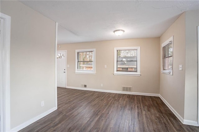 unfurnished room featuring dark hardwood / wood-style floors