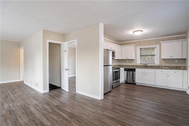 kitchen with stainless steel appliances, sink, white cabinets, and dark hardwood / wood-style floors