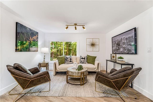 sitting room featuring wood finished floors and baseboards
