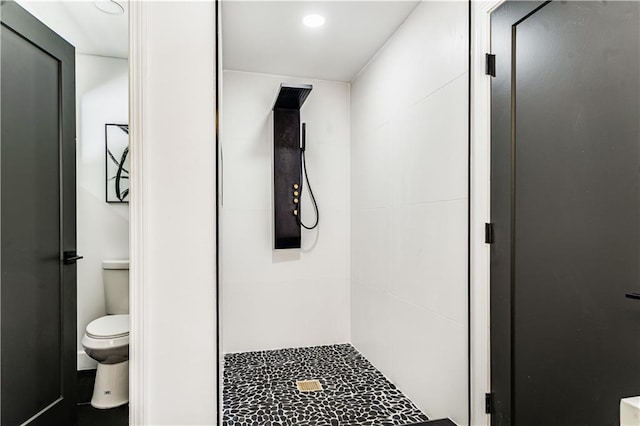 full bathroom with a shower stall and toilet
