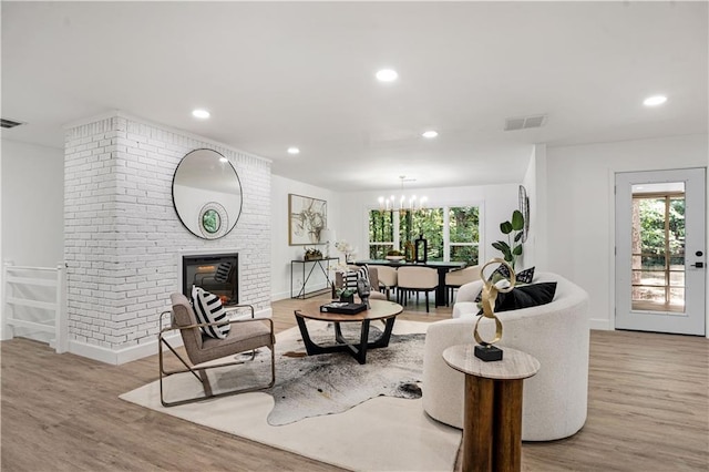 living room featuring wood finished floors, visible vents, and a healthy amount of sunlight