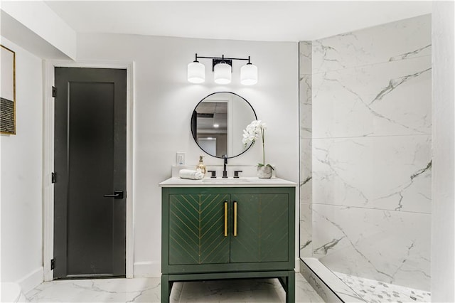 bathroom featuring baseboards, marble finish floor, vanity, and a marble finish shower