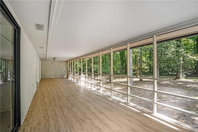 unfurnished sunroom with visible vents