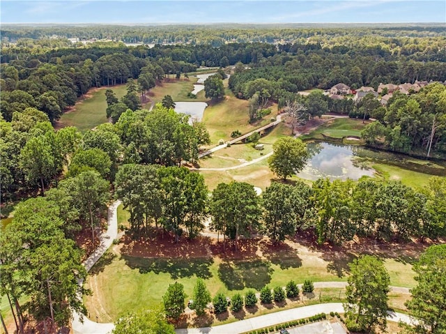 birds eye view of property with a water view and a wooded view