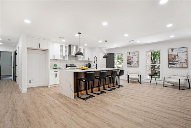 kitchen with stainless steel electric range oven, baseboards, recessed lighting, and light wood-style floors