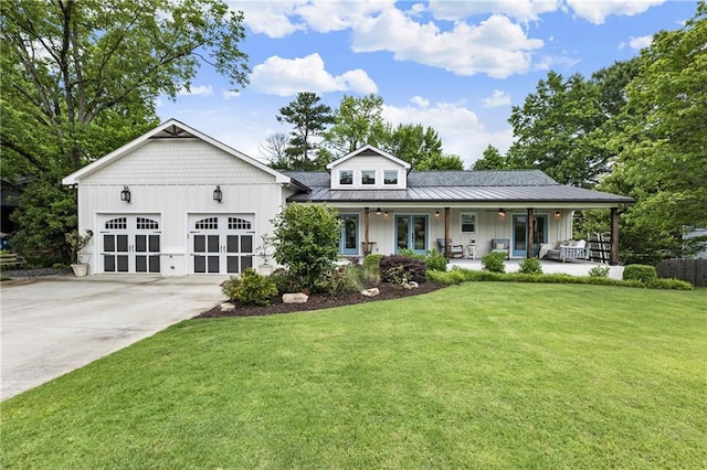 221 Brooke Dr, Alpharetta, GA 30009 - view of front facade featuring a front yard, board and batten siding, french doors, driveway, and a standing seam roof