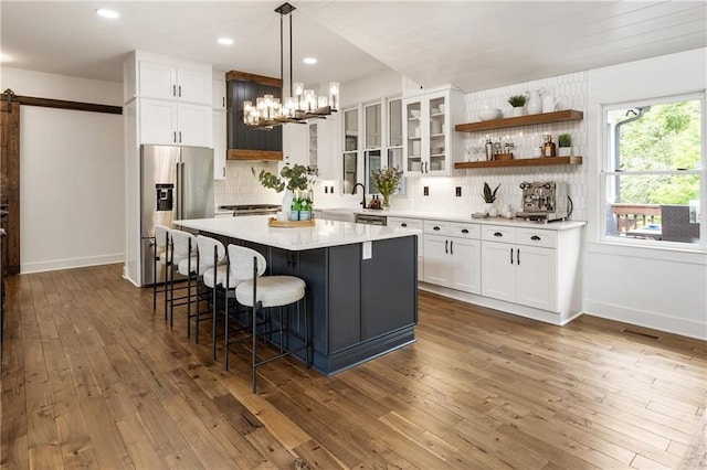 221 Brooke Dr, Alpharetta, GA 30009 - kitchen featuring stainless steel fridge, white cabinets, a breakfast bar, tasteful backsplash, and recessed lighting