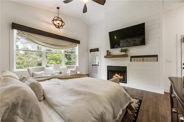 221 Brooke Dr, Alpharetta, GA 30009 - bedroom with lofted ceiling, dark wood-type flooring, a large fireplace, baseboards, and a ceiling fan