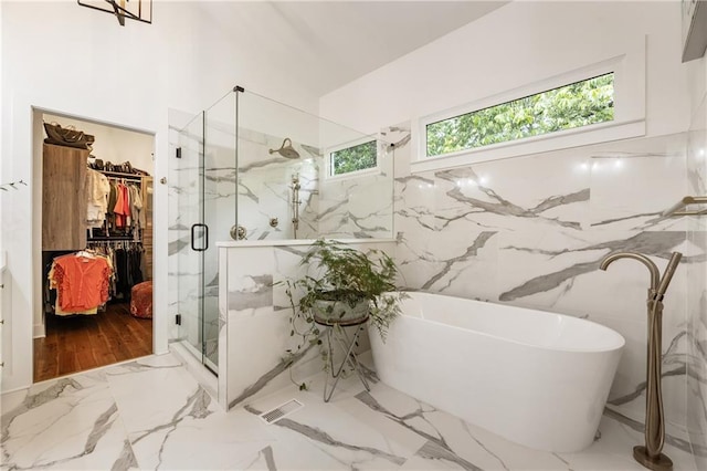 221 Brooke Dr, Alpharetta, GA 30009 - bathroom featuring a marble finish shower, a walk in closet, a soaking tub, and marble tiled floors