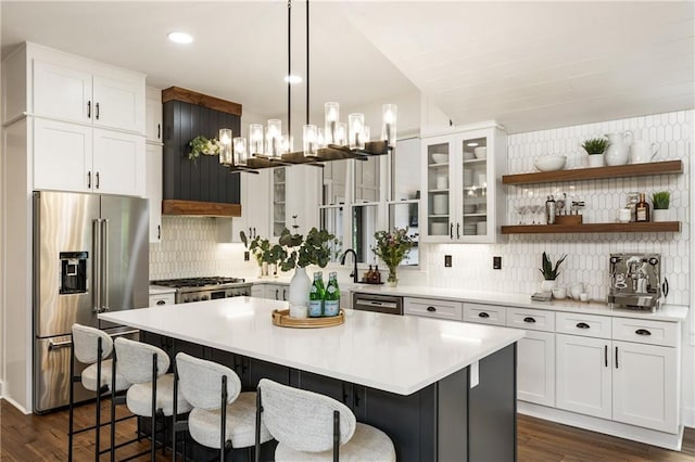 221 Brooke Dr, Alpharetta, GA 30009 - kitchen with appliances with stainless steel finishes, decorative backsplash, a kitchen bar, white cabinetry, and recessed lighting
