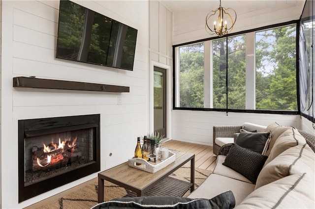 221 Brooke Dr, Alpharetta, GA 30009 - living area with wood finished floors, a chandelier, a lit fireplace, and wood walls
