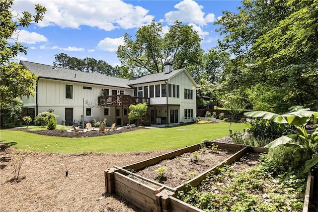 221 Brooke Dr, Alpharetta, GA 30009 - back of house featuring a garden, a yard, a deck, a patio area, and a sunroom