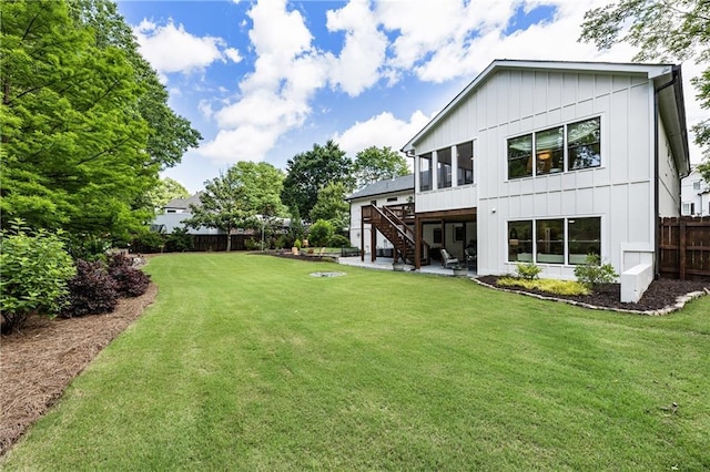 221 Brooke Dr, Alpharetta, GA 30009 - back of house with board and batten siding, stairs, a wooden deck, and a patio