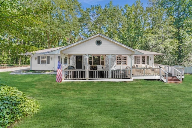 rear view of property featuring a wooden deck and a lawn