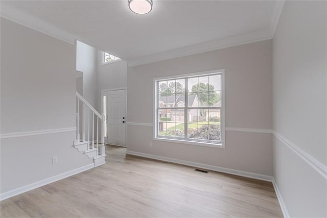1706 Brandon Lee Way SW, Marietta, GA 30008 - spare room with healthy amount of natural light, stairs, crown molding, and wood finished floors