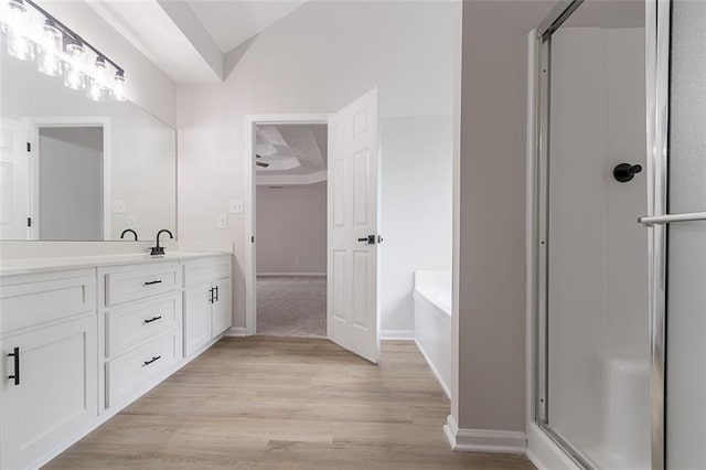 1706 Brandon Lee Way SW, Marietta, GA 30008 - full bathroom with vanity, a shower stall, wood finished floors, a bath, and vaulted ceiling