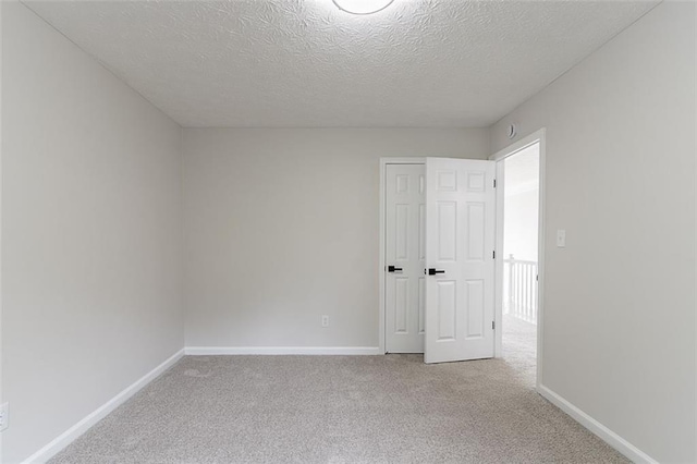 1706 Brandon Lee Way SW, Marietta, GA 30008 - unfurnished bedroom with light colored carpet, a textured ceiling, and baseboards