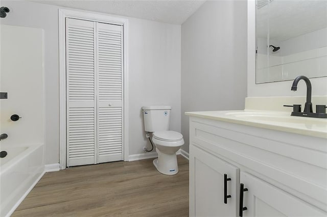 1706 Brandon Lee Way SW, Marietta, GA 30008 - full bathroom with a closet, vanity, toilet, wood finished floors, and  shower combination