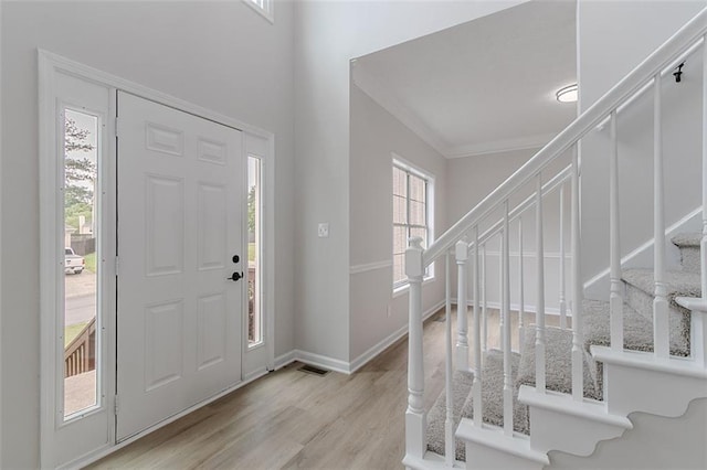 1706 Brandon Lee Way SW, Marietta, GA 30008 - foyer entrance featuring stairs, crown molding, wood finished floors, and baseboards