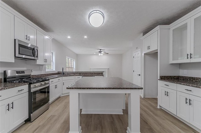 1706 Brandon Lee Way SW, Marietta, GA 30008 - kitchen featuring appliances with stainless steel finishes, light wood-type flooring, ceiling fan, a sink, and a textured ceiling