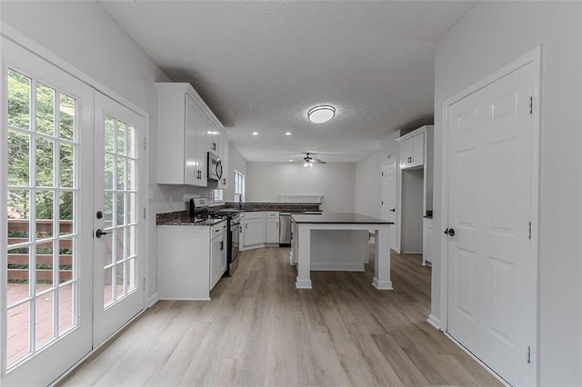 1706 Brandon Lee Way SW, Marietta, GA 30008 - kitchen with appliances with stainless steel finishes, dark countertops, ceiling fan, and light wood-style floors