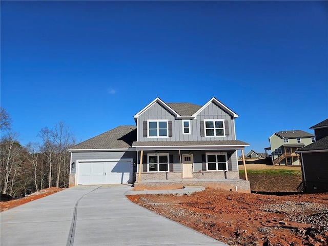 view of front of house featuring a porch and a garage