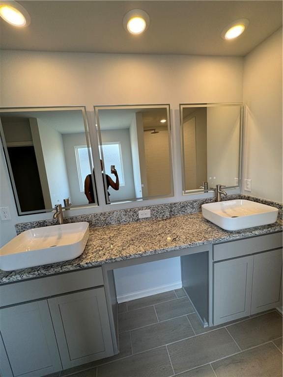 bathroom featuring tile patterned flooring and vanity