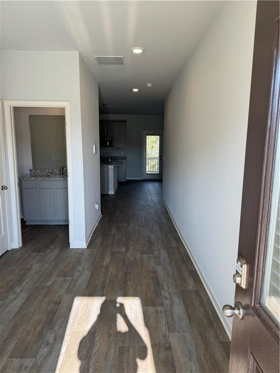 corridor featuring dark hardwood / wood-style floors