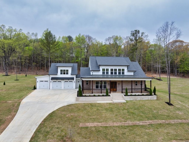 modern farmhouse style home featuring roof with shingles, an attached garage, driveway, a front yard, and a porch