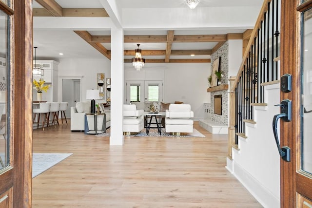 foyer with coffered ceiling, stairs, baseboards, beamed ceiling, and light wood finished floors