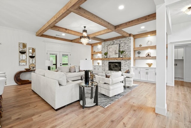 living area with a brick fireplace, french doors, baseboards, beam ceiling, and light wood-style flooring