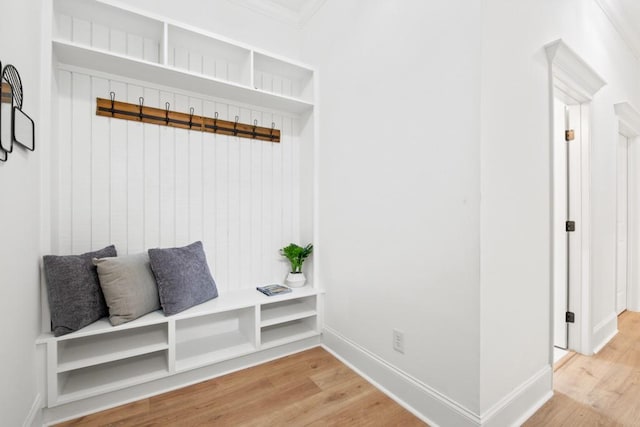 mudroom with light wood finished floors and baseboards