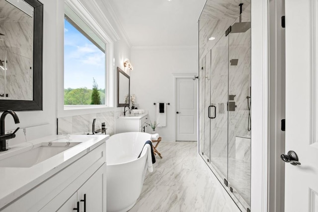 full bath with vanity, a marble finish shower, a soaking tub, marble finish floor, and ornamental molding