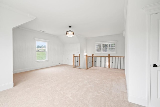 unfurnished room with carpet flooring, ornamental molding, and baseboards