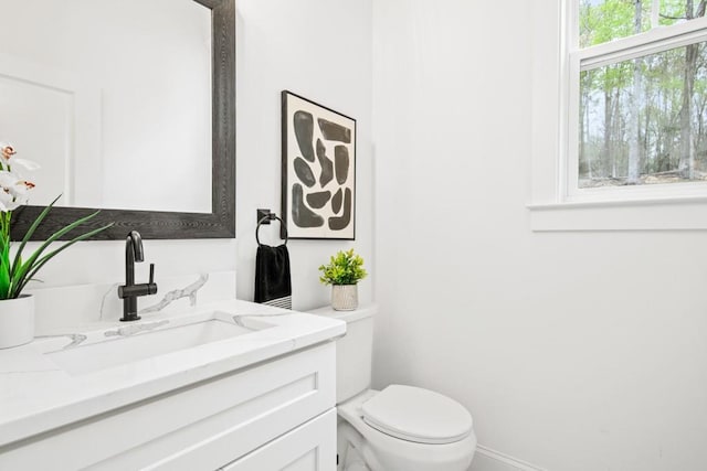 bathroom featuring toilet and vanity