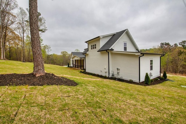 view of home's exterior with a yard