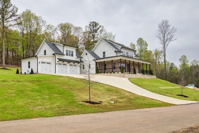 modern farmhouse style home featuring a porch, driveway, an attached garage, and a front lawn