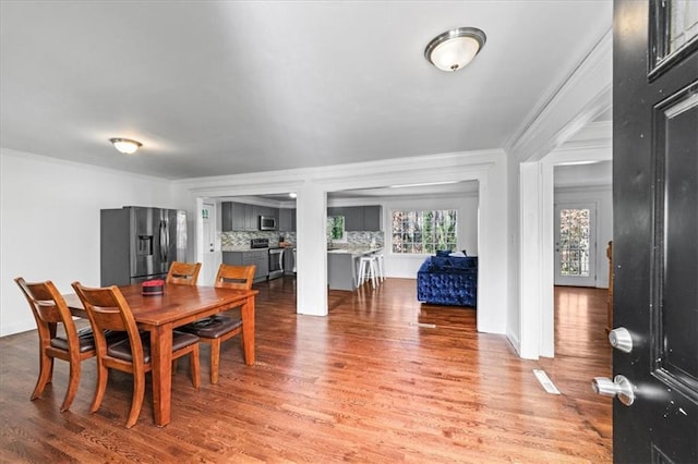 dining area featuring crown molding and wood finished floors