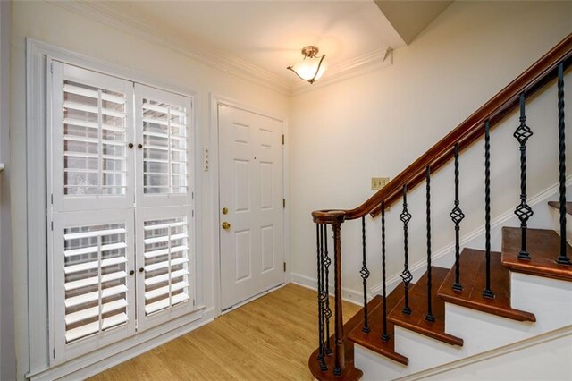 7500 Roswell Rd Unit 18, Sandy Springs, GA 30350 - entrance foyer with wood finished floors, stairway, and ornamental molding