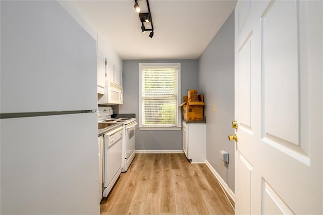 7500 Roswell Rd Unit 18, Sandy Springs, GA 30350 - kitchen with white appliances, light wood finished floors, white cabinets, and baseboards