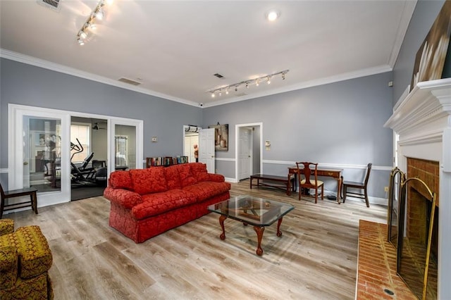 7500 Roswell Rd Unit 18, Sandy Springs, GA 30350 - living area featuring rail lighting, wood finished floors, crown molding, baseboards, and a fireplace