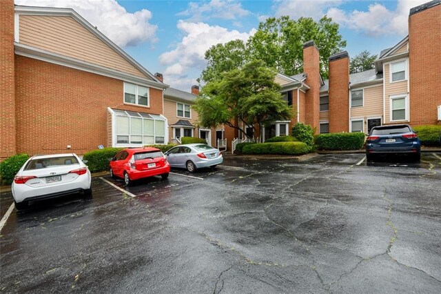 7500 Roswell Rd Unit 18, Sandy Springs, GA 30350 - uncovered parking lot featuring a residential view