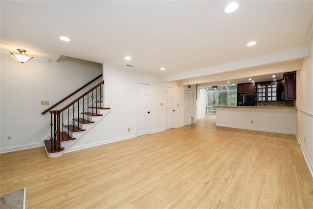 7500 Roswell Rd Unit 18, Sandy Springs, GA 30350 - unfurnished living room featuring light wood-type flooring, recessed lighting, stairway, and baseboards
