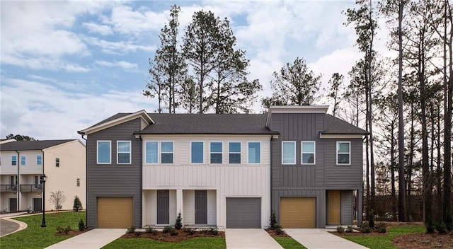 1714 Gunnin Trce NW, Atlanta, GA 30318 - view of front of house featuring board and batten siding, driveway, a front lawn, and an attached garage
