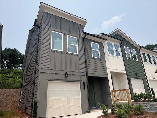 1714 Gunnin Trce NW, Atlanta, GA 30318 - view of front of house with board and batten siding and a garage