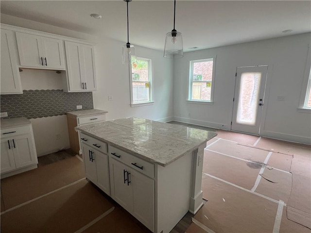 1714 Gunnin Trce NW, Atlanta, GA 30318 - kitchen with white cabinetry, tasteful backsplash, a center island, hanging light fixtures, and light stone countertops