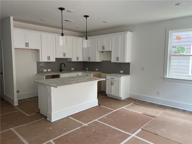 1714 Gunnin Trce NW, Atlanta, GA 30318 - kitchen with backsplash, white cabinets, a center island, and decorative light fixtures