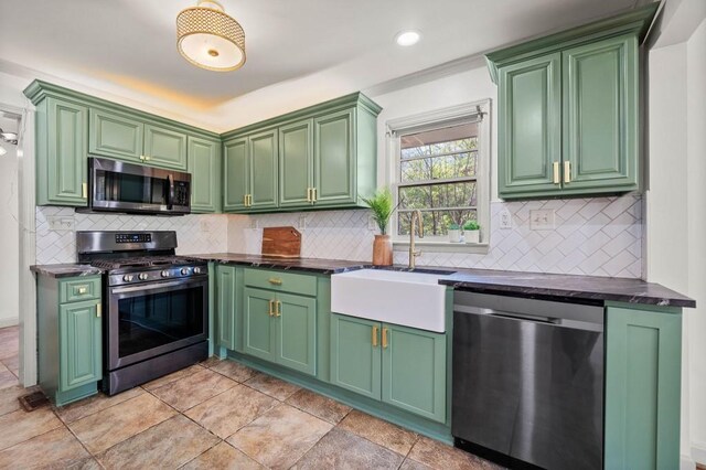 1286 Calhoun Ter SW, Atlanta, GA 30314 - kitchen featuring a sink, dark countertops, appliances with stainless steel finishes, and decorative backsplash