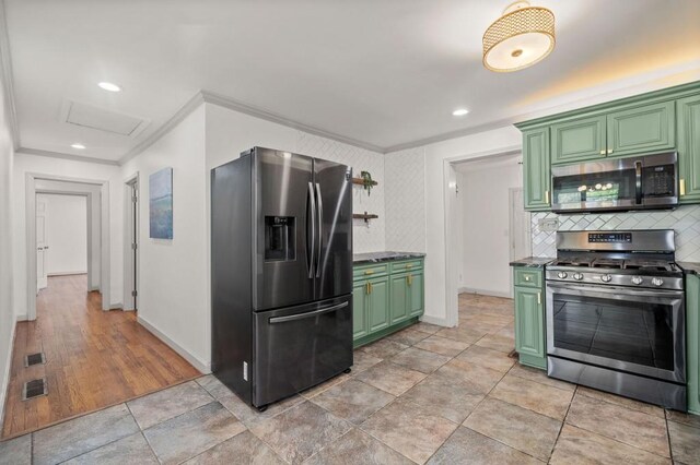 1286 Calhoun Ter SW, Atlanta, GA 30314 - kitchen featuring green cabinetry, ornamental molding, and appliances with stainless steel finishes