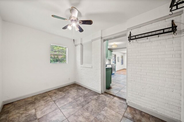 1286 Calhoun Ter SW, Atlanta, GA 30314 - unfurnished room with baseboards, ceiling fan, and brick wall